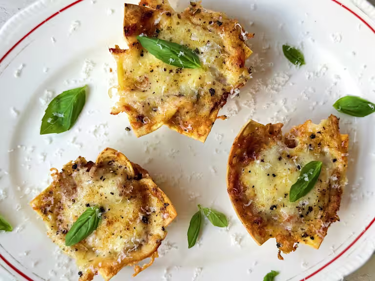 Vegetarian lasagne bites with Quorn Mince, topped with cheese and basil