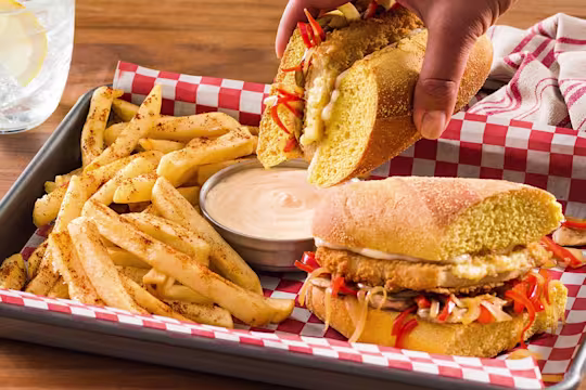 Meat-free Hoagie on tray with chips and dipping sauce