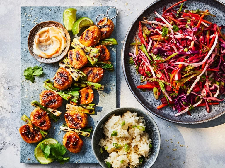Three sticky gochujang skewers made with Quorn fillet pieces with an Asian slaw on the side.