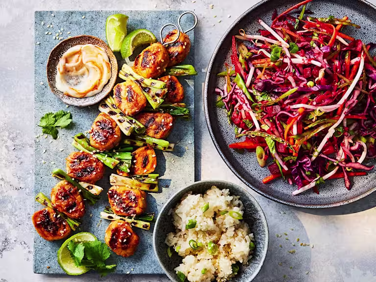 Three sticky gochujang skewers made with Quorn fillet pieces with an Asian slaw on the side.