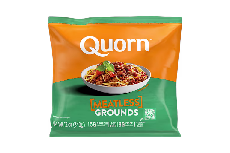 A bag and a box of Quorn Meatless Grounds showing the plated product and information on an orange and charcoal background.