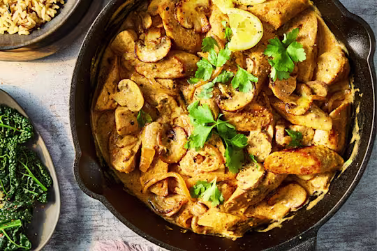 Quorn sausages in a stroganoff sauce with mushrooms in a skillet pan