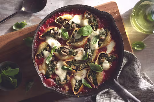 Conchiglioni pasta stuffed with Quorn Sausages and spinach in a tomato sauce topped with cheese and basil.