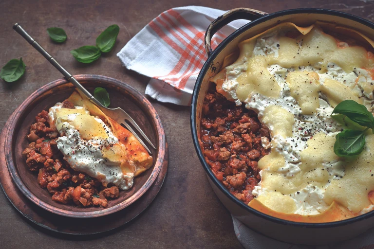 Quick and easy meal of lasagne made with Quorn Mince served in a saucepan and a side serving in a small bowl