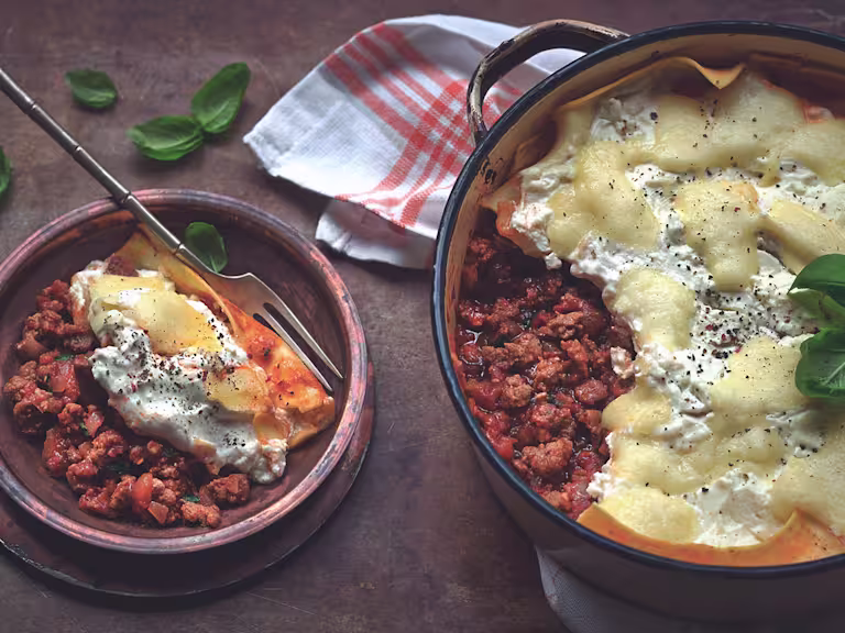 Quick and easy meal of lasagne made with Quorn Mince served in a saucepan and a side serving in a small bowl