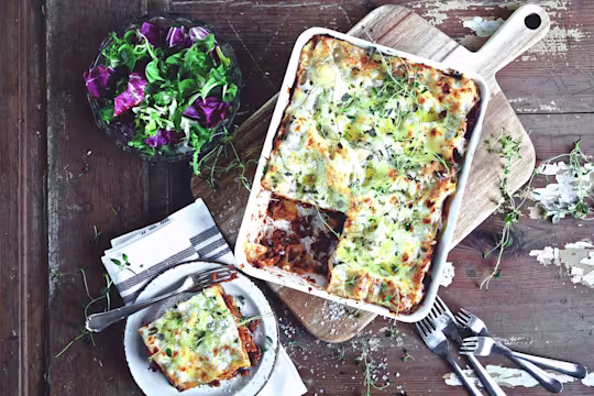 Quick and easy meal of lasagne made with Quorn Mince served in a saucepan and a side serving in a small bowl