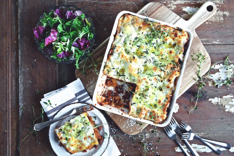 Quick and easy meal of lasagne made with Quorn Mince served in a saucepan and a side serving in a small bowl