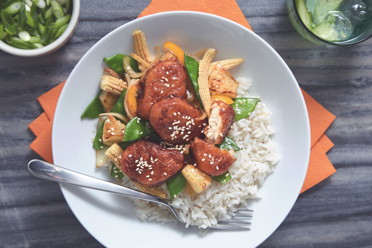 A bowl of Sticky Sweet & Sour Quorn Nuggets served on top of warm rice.