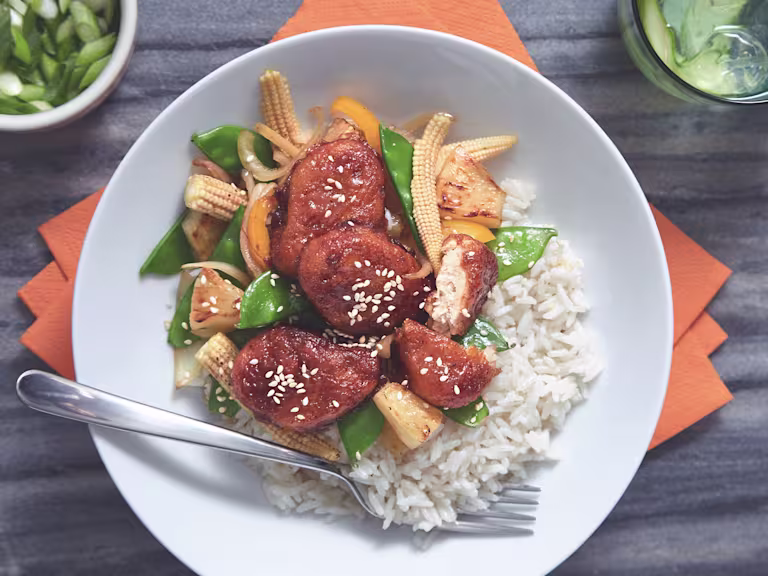 A bowl of Sticky Sweet & Sour Quorn Nuggets served on top of warm rice.