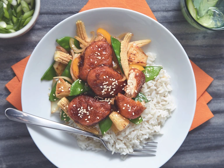 A bowl of Sticky Sweet & Sour Quorn Nuggets served on top of warm rice.