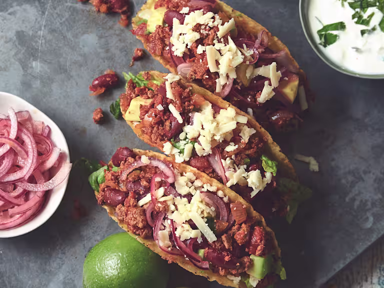 Vegetarian chipotle tacos made with Quorn mince accompanied with pickled onion and sour cream