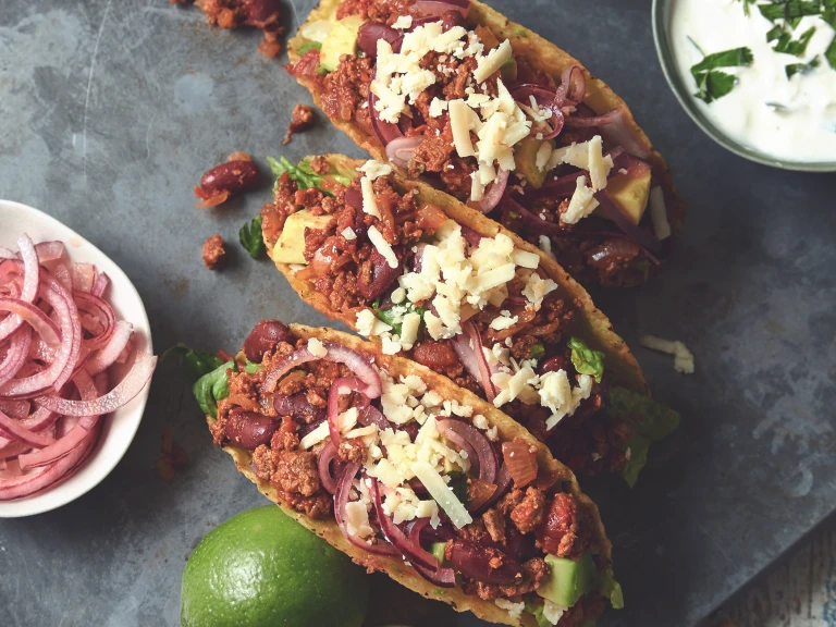 Vegetarian chipotle tacos made with Quorn mince accompanied with pickled onion and sour cream