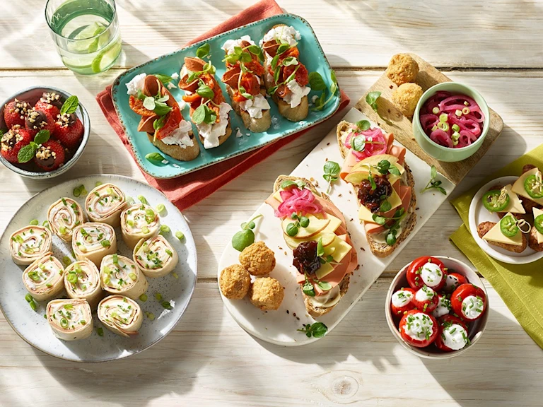 Vegetarian lunch recipe made with Quorn Sausage and pasta served in colourful Tupperware containers and cutlery