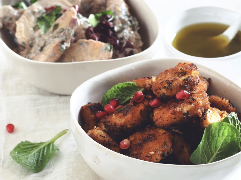 Vegetarian Moroccan recipe made with Quorn Crispy Nuggets served in a bowl garnished with pomegranate and green leaves