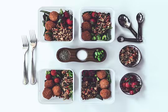 Healthy salad recipe made with Quorn Mini Savoury Eggs, pilaf rice and quinoa served in individual Tupperware boxes