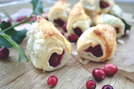 Quorn Vegetarian Cocktail Sausages with cranberry and served with cranberries on a chopping board