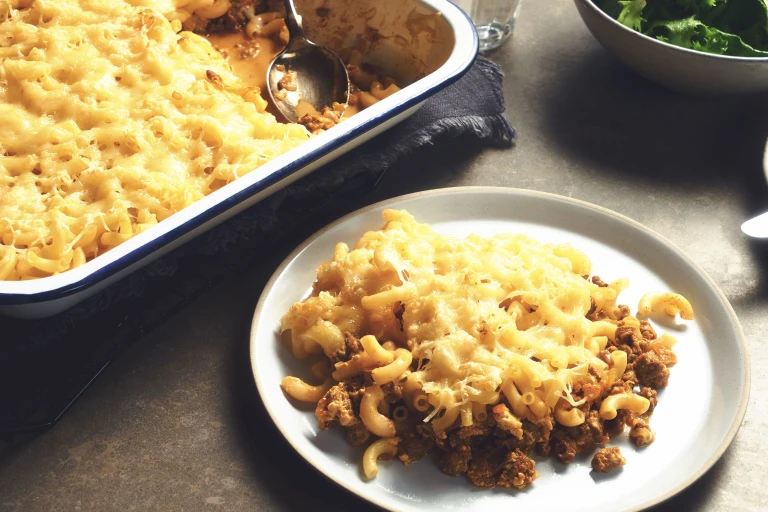 A porition of Quorn Vegetarian Mac And Cheese made using Quorn Meatless Grounds with a full dish on the side. 