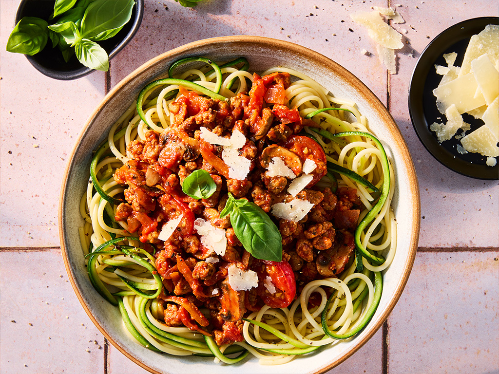 Quorn Zucchini Bolognese, made with Quorn Grounds, carrots, mushrooms, celery and onion, served on a plate 