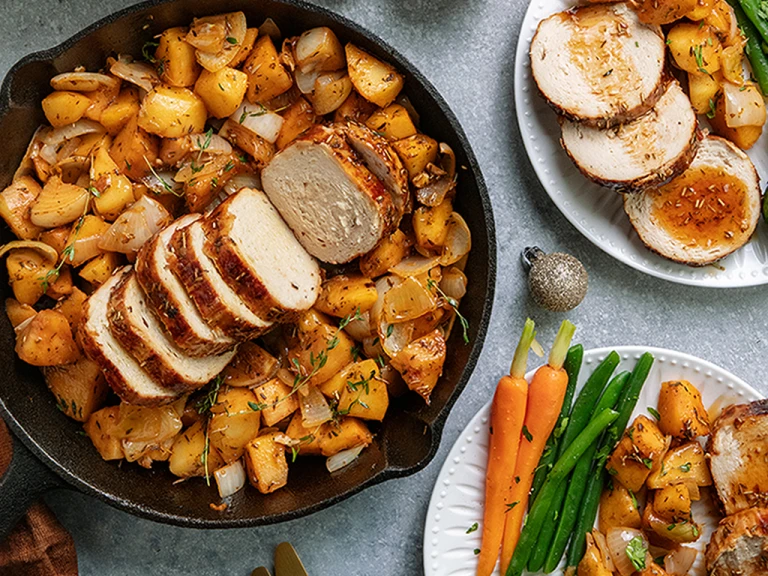 One-pot maple glazed Christmas roast served in a dish with Quorn Roast and roasted vegetables on the side.