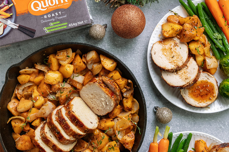 One-pot maple glazed Christmas roast served in a dish with Quorn Roast and roasted vegetables on the side.
