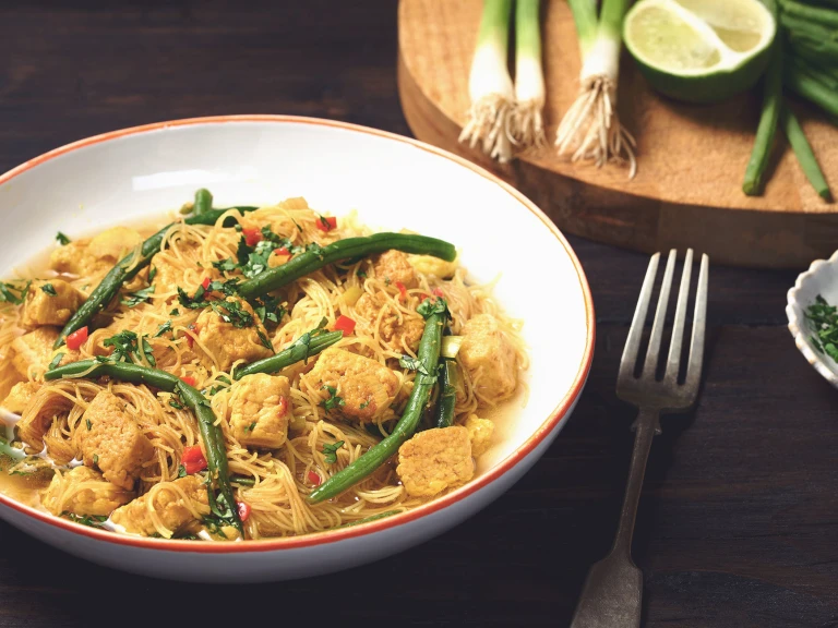 A bowl of Laksa made with Quorn pieces, chilli and ginger, and served with rice noodles.