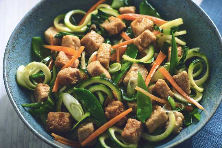 Vegetarian stir fry with Quorn Meatless pieces and zuccini noodles served in a bowl