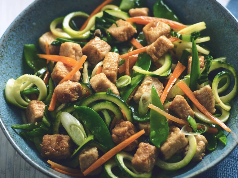 Vegetarian stir fry with Quorn Meatless pieces and zuccini noodles served in a bowl