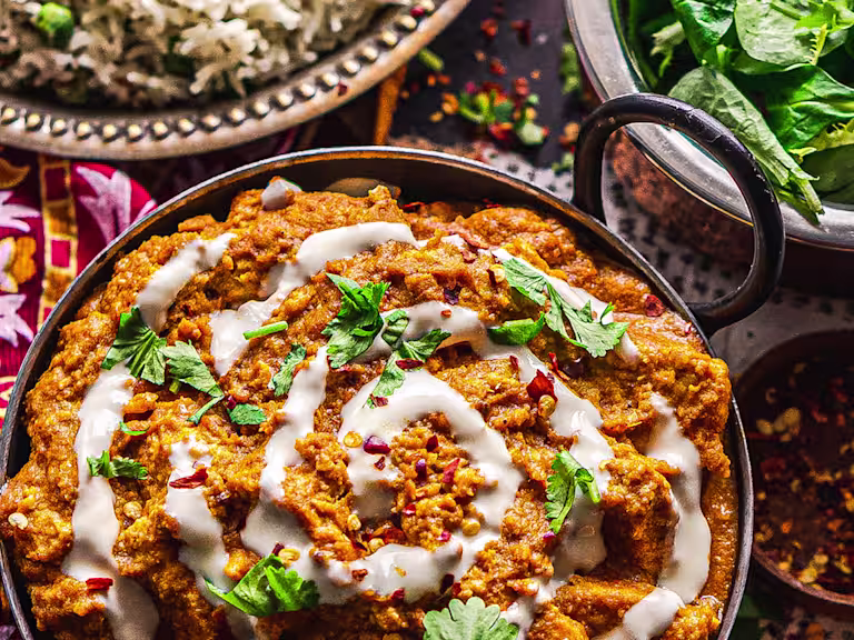 Spicy meat-free butter chicken served in a dark dish.