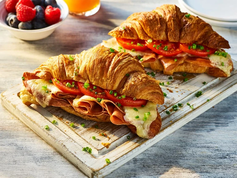 Two Air Fryer Vegetarian Croissants with the filling visible including Quorn Ham, sliced tomatoes and melted cheese.