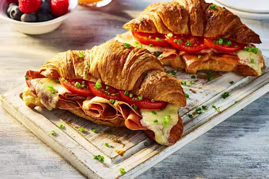 Two Air Fryer Vegetarian Croissants with the filling visible including Quorn Vegetarian Ham, sliced tomatoes and melted cheese.