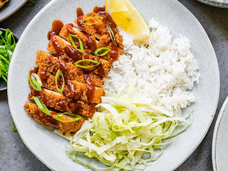 A plate of Quorn Vegetarian Chicken Katsu curry featuring Quorn Homestyle ChiQin Cutlets slices and a side of rice. 