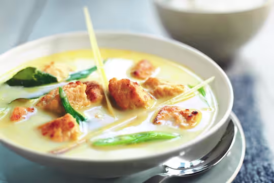 Vegetarian Thai Green Curry, made with Quorn Pieces, coconut milk, lime, soy sauce, onion, served in a bowl.