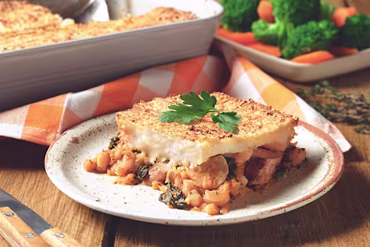 Veggie Sausage and Bean Pie, made with Quorn sausages, tomato, beans, carrot and onion, served on a plate with mixed veg.
