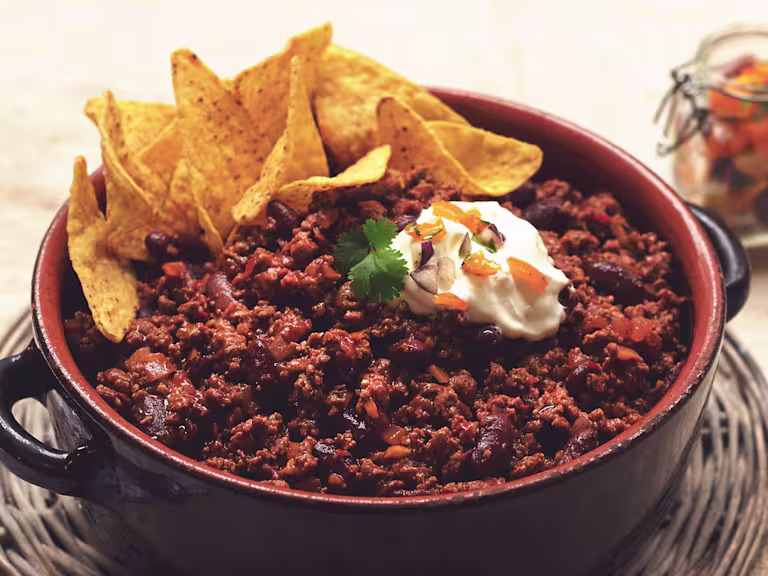 Vegetarian Quorn Chilli con Carne served in a casserole dish topped with nachos