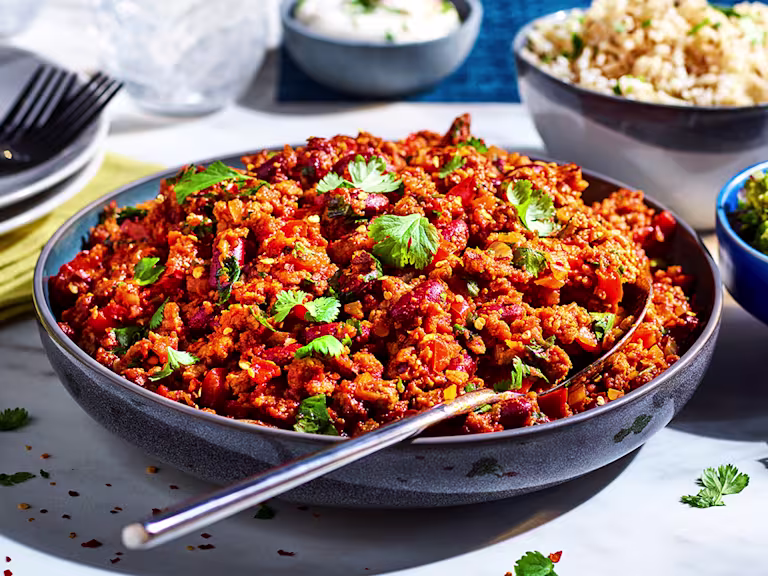 Vegetarian Chilli con Carne made with meat free Quorn Mince, served in a sauce pan with tortilla chips on the side