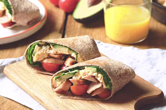 Quorn Vegetarian Breakfast Burrito, sliced in half to showcase the filling, including sliced Quorn Vegetarian Sausages.