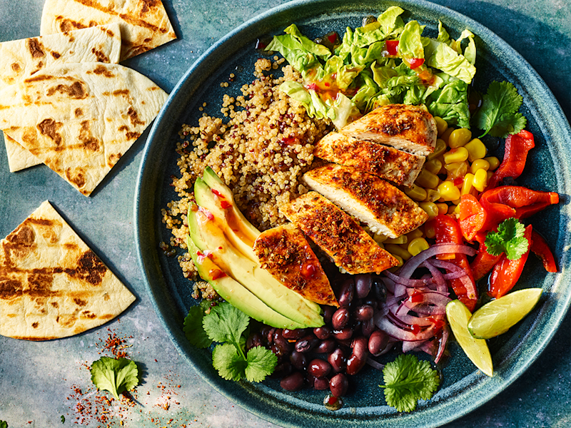 Naked burrito bowl with Quorn fillets served in a bowl with pitta bread on the side.