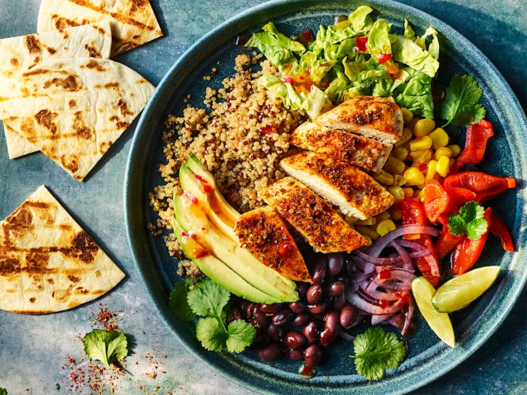 Naked burrito bowl with Quorn fillets served in a bowl with pitta bread on the side.