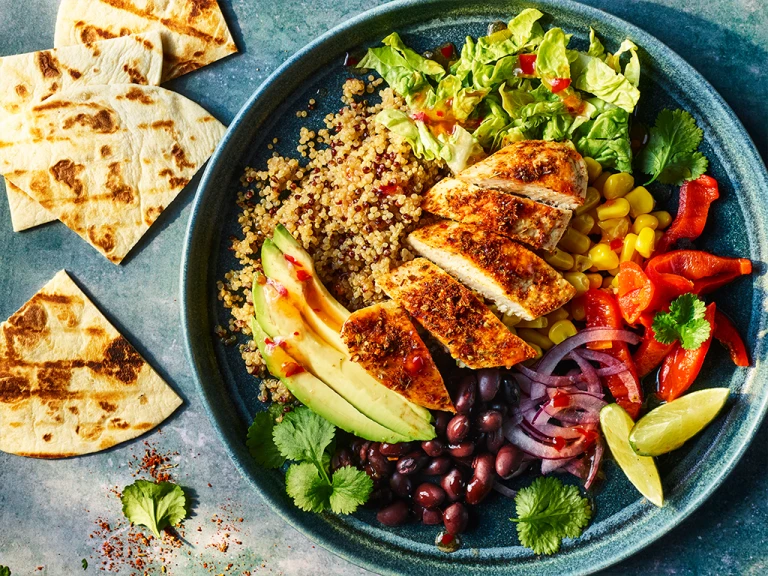 Naked burrito bowl with Quorn fillets served in a bowl with pitta bread on the side.
