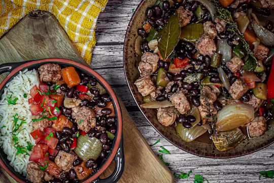 Vegetarian Feijoada with black beans and Quorn Pieces in a bowl and pot