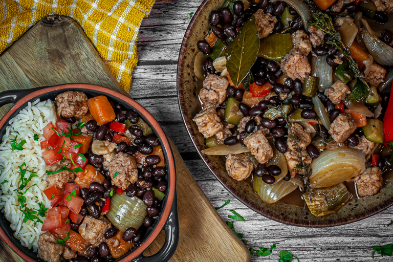 Vegetarian Feijoada with black beans and Quorn Pieces in a bowl and pot