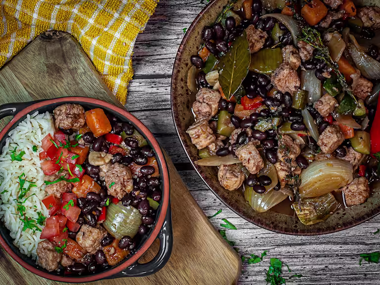 Vegetarian Feijoada with black beans and Quorn Pieces in a bowl and pot