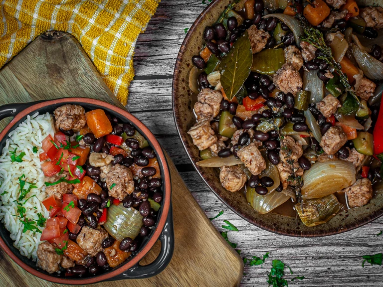 Vegetarian Feijoada with black beans and Quorn Pieces in a bowl and pot