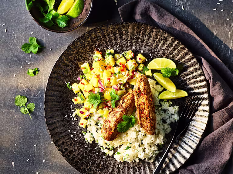 Quorn Tikka Mini Fillets with Sticky Coconut Rice served in a bowl with avocado on the side.