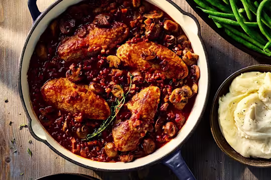 Vegetarian Co au Vin made using Quorn Fillets served in a large dish with a side dish of mashed potatoes.