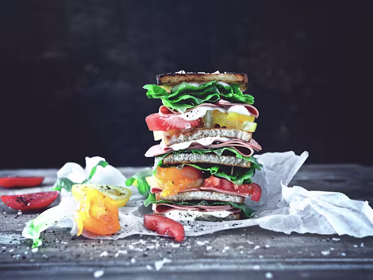 VLT with Quorn Vegan Smoky Ham Slices, mayonaise, lettuce and tomato on bread.