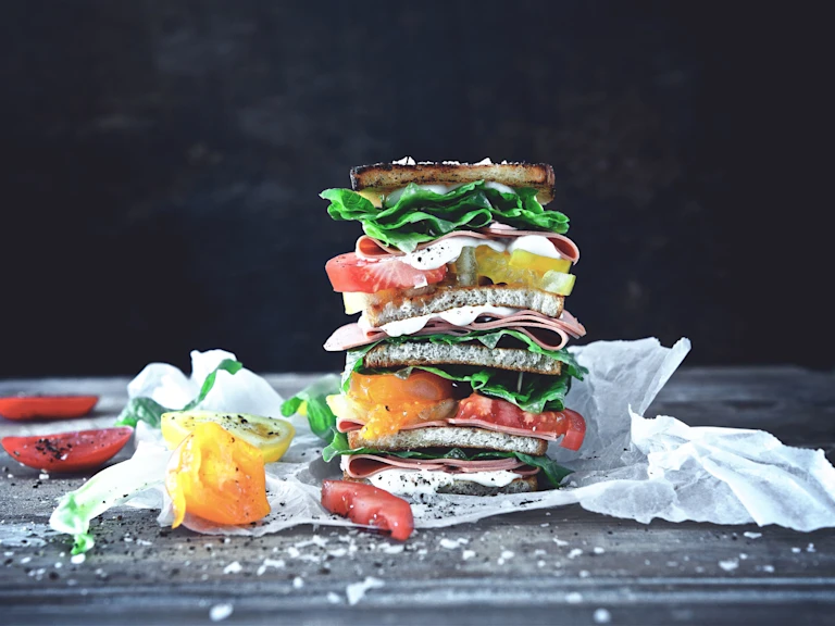 VLT with Quorn Vegan Smoky Ham Slices, mayonaise, lettuce and tomato on bread.