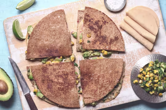 Vegetarian quesadilla of Quorn Vegan Chicken Free Slices, avocado and sweetcorn between tortilla wraps, cut into quarters