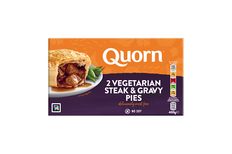A box of Quorn Steak & Gravy Pies showing the prepared product and information on an orange and charcoal background.