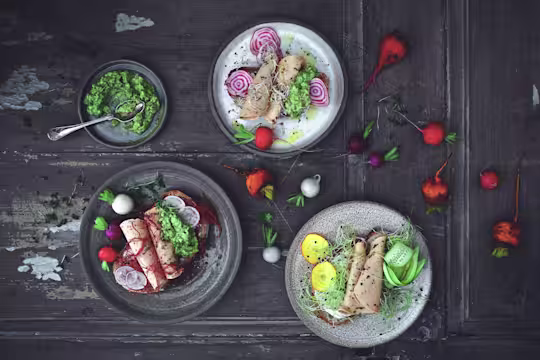 Quorn Spinach and Red Pepper Slices served on sliced bread with beetroot, radish and cress on a table scattered with radishes
